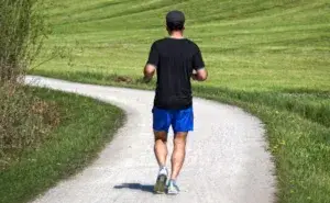 Runner on a quiet trail practising how to run a mile without stopping