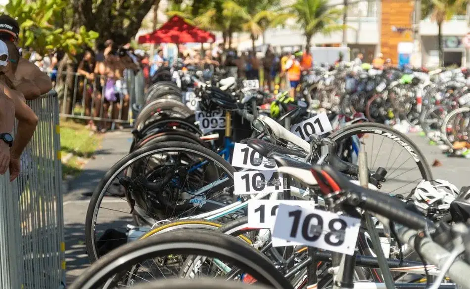 Athletes setting up bikes in transition showing how to train for a triathlon when you're short on time