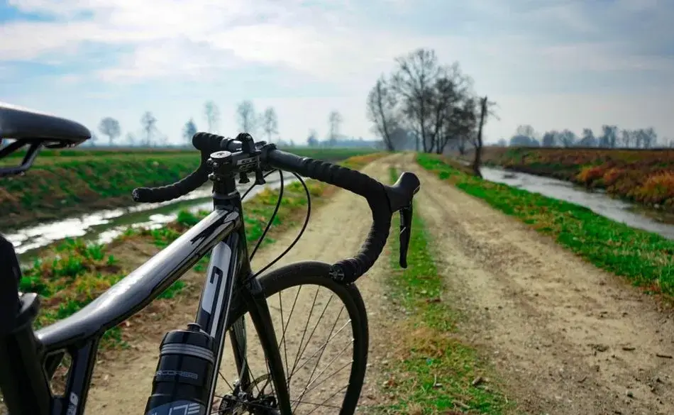 how to train for gravel bike on dirt road with scenic countryside view