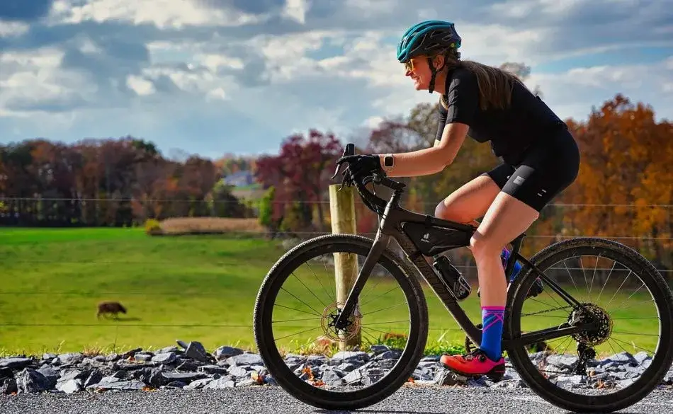 woman cycling outdoors working to increase FTP for cycling beginners