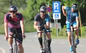 Triathletes riding during a race showcasing why many athletes ask is hiring a triathlon coach worth it