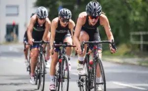 Cyclists riding hard in a group during a lactate threshold cycling effort.