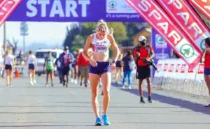 female runner adjusting top before race start to prevent nipple chafing when running