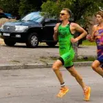 triathletes running off the bike during a race transition