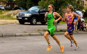 triathletes running off the bike during a race transition