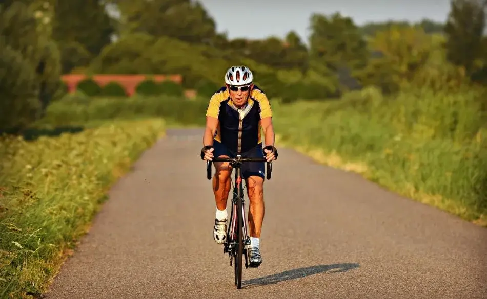 cyclist riding steadily during sweet spot cycling training on a quiet country road