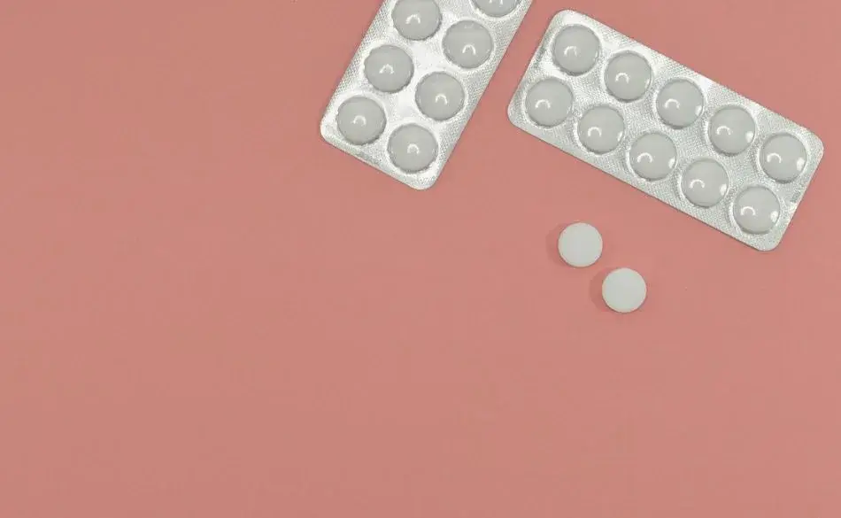 Aspirin and running performance illustrated by tablets and blister packs on a flat background