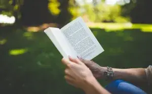 person outside reading one of the best triathlon training books available