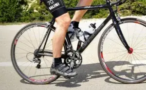 cyclist practicing cycling cadence drills for beginners on an outdoor climb