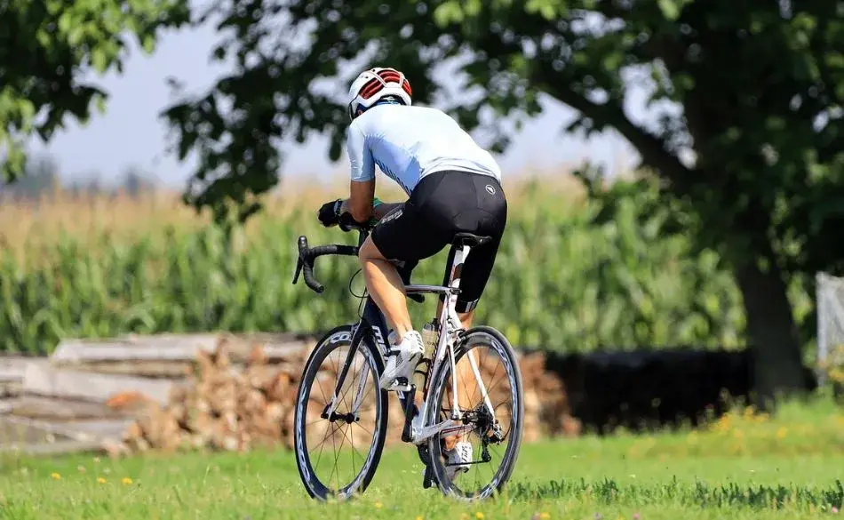 does cycling tone your bum? Road cyclist riding outdoors showing glute engagement