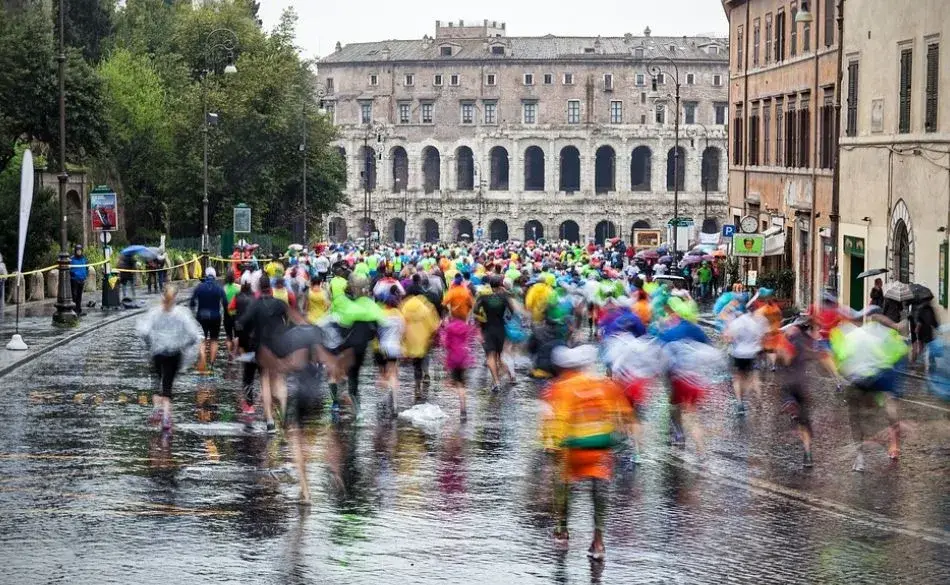 Runners racing on wet streets during a marathon while running in the rain