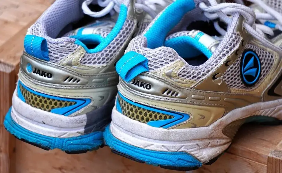 Worn running shoes showing midsole compression and highlighting the need for a running shoe rotation.