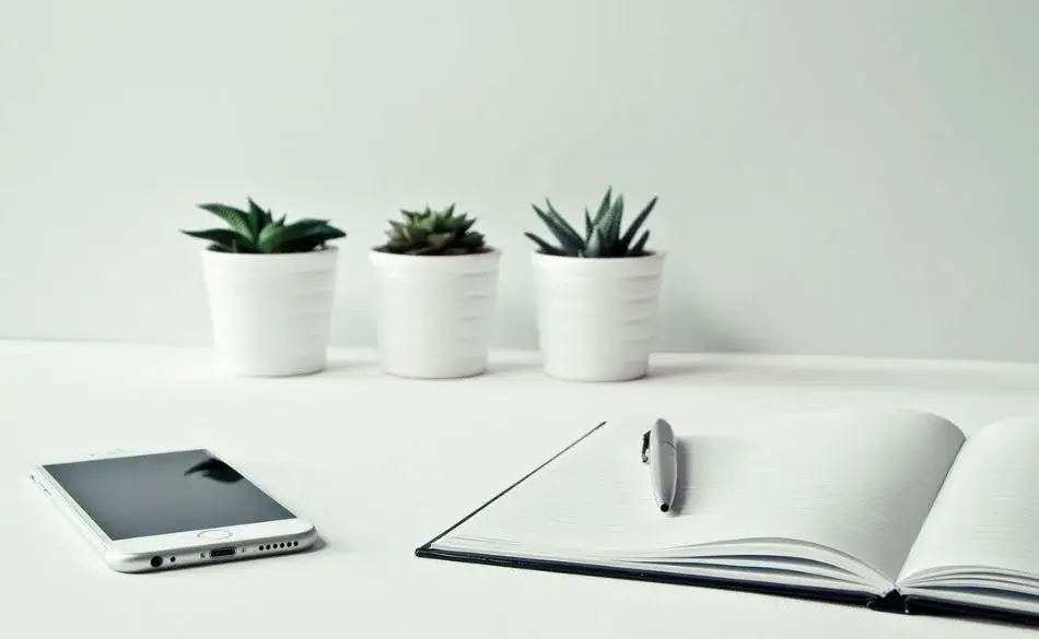 open notebook and pen on a desk used for keeping a running training log