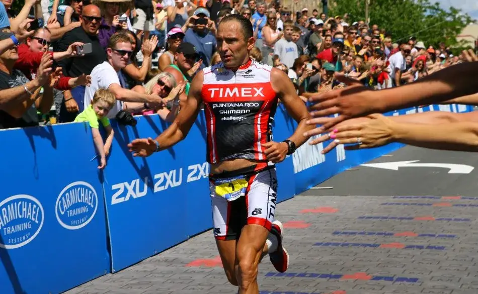 Triathlete running the final leg of an Ironman race after long bike and swim sections