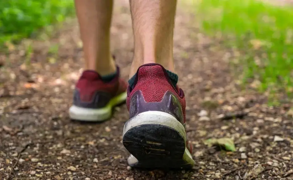 Runner building mileage safely for first-time marathon training on an outdoor path