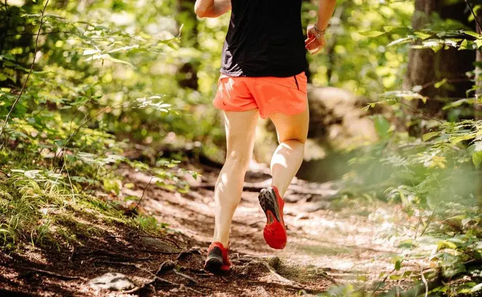 trail runner during ultra training showing how to train for ultra running on uneven terrain