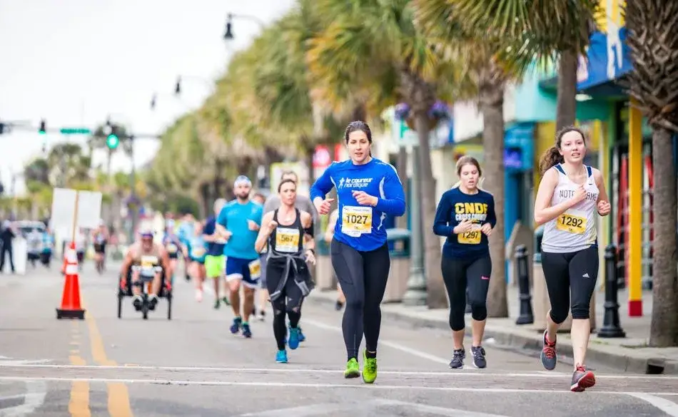 Runners taking part in a 10km road race on a city street