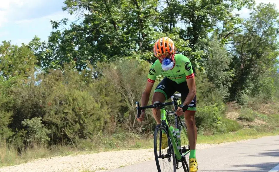 Cyclist riding uphill showing power to weight performance during FTP training