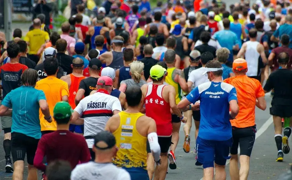 Large group of runners participating in a half marathon road race