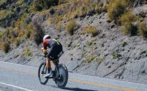 Triathlete riding in aerodynamic position during an Ironman 180km bike leg