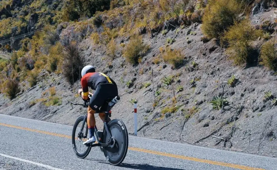 Triathlete riding in aerodynamic position during an Ironman 180km bike leg
