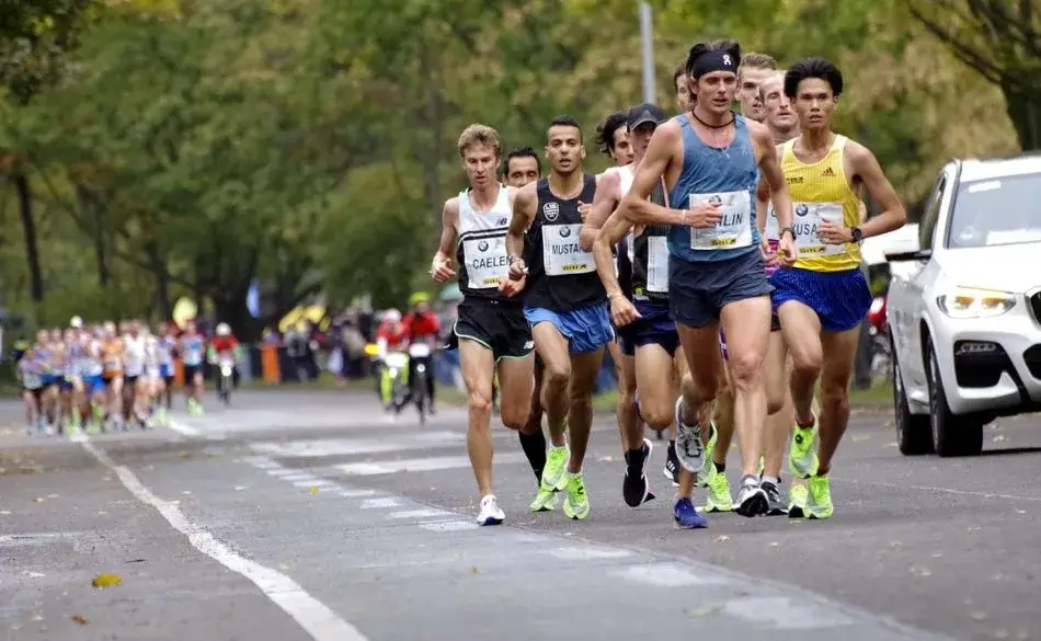 Runners training together during a 10km road race showing proper pacing and endurance