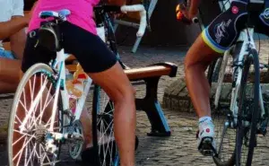 Two cyclists stopped at rest stop showing cycling shorts and saddle contact area