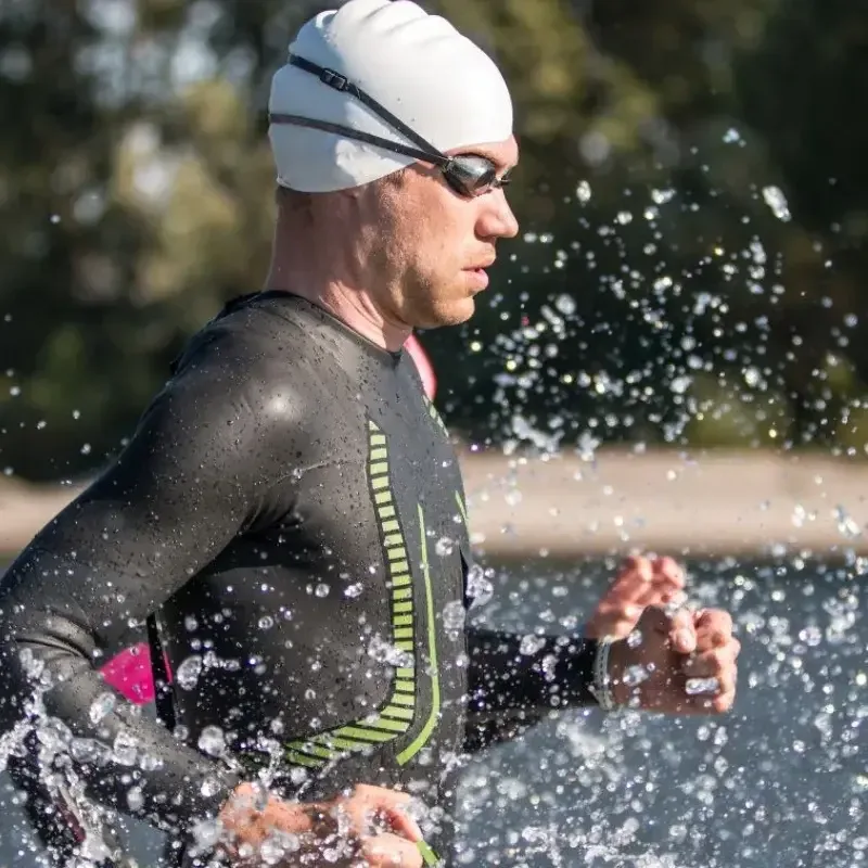 Gold Coast triathlon coach leading open-water swim training session with athlete.