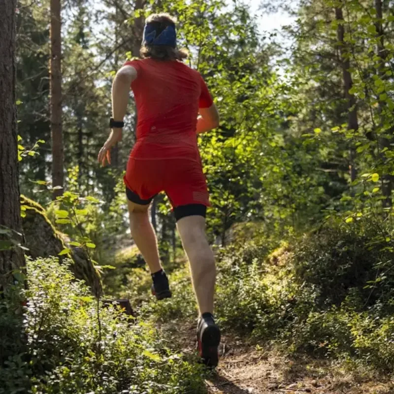 Triathlete running through a forest trail during Perth triathlon coaching session, building endurance and strength for race day.