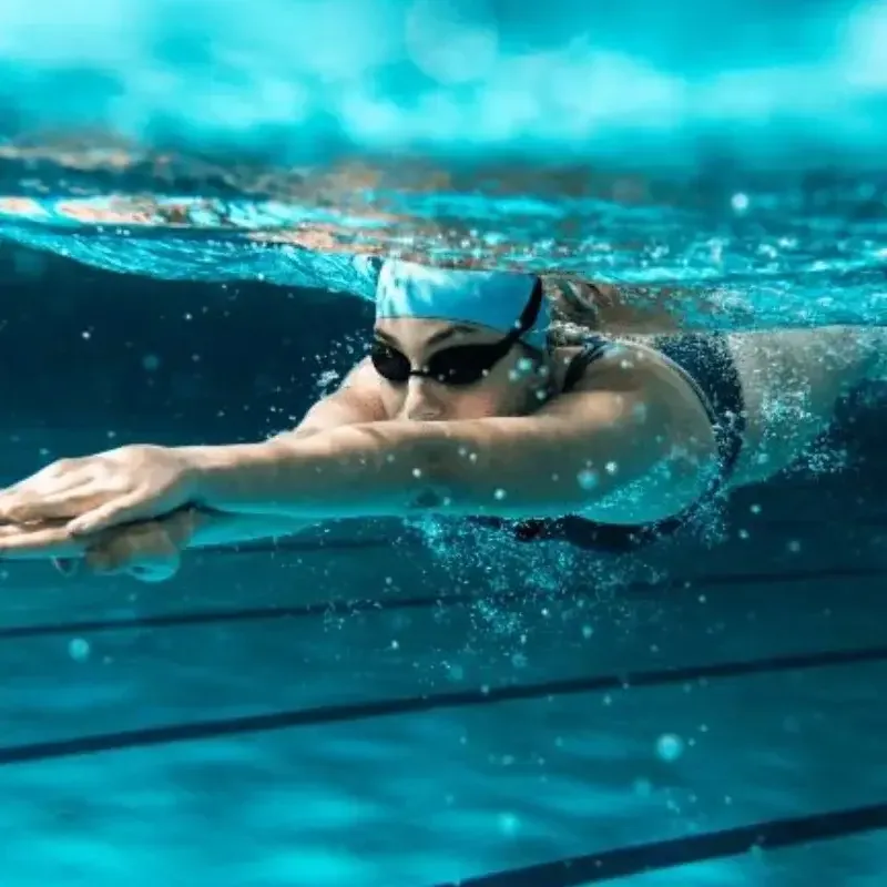 Wellington triathlon coach guiding athlete through swim training session in pool